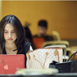 laTD 2016 someone working on a laptop in library