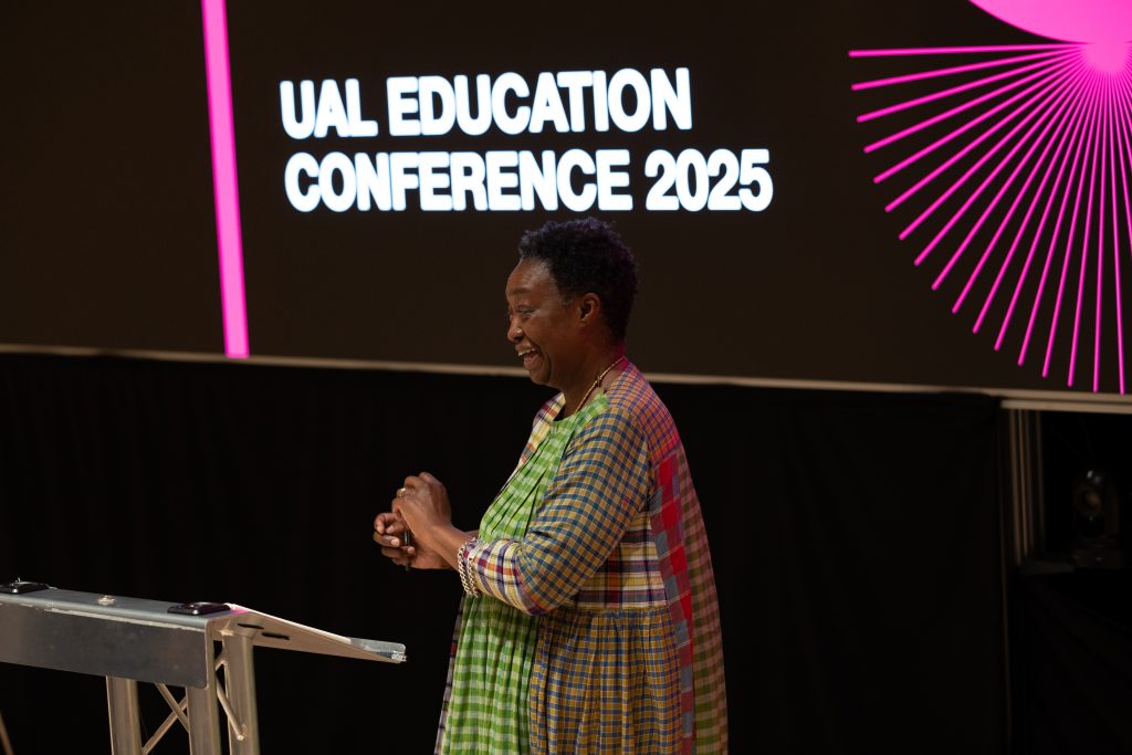a presenter in front of a big projection screen that reads UAL EDUCATION CONFERENCE 2025