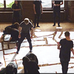 People assembling paper puzzle pieces on the floor of a conference room