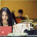 someone working on a laptop in  library