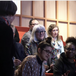 Attendees discussing something in a lecture theatre